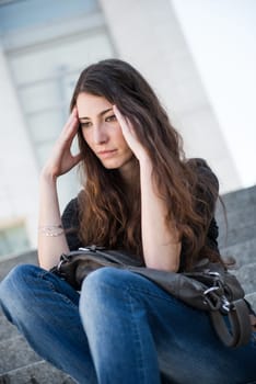 Young woman in depression  - outdoor portrait, negative expression