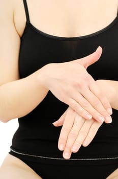 Woman in underwear applies cream on dry hands