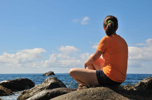 Young person relaxing and looking on sea view - vacation scene