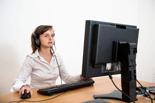 Business person (young woman) works at table with computer