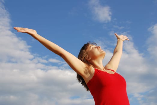Young woman enjoying life outddors with hands to the sky