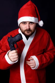 young man dressed as santa with a gun