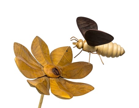Model of a wooden bee flies towards a wooden flower, isolated on white