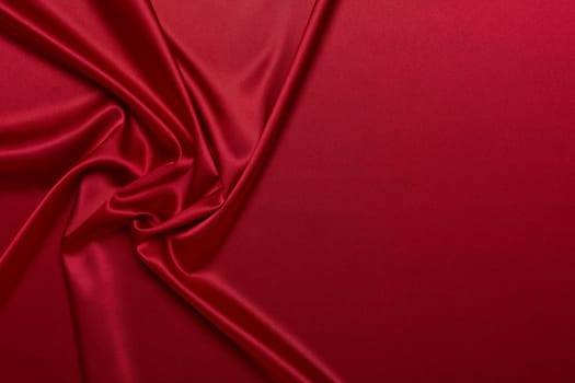 Abstract background from red silk or satin. Luxury fabric texture with draped. Top view with copy space. Element design. Valentine's day.