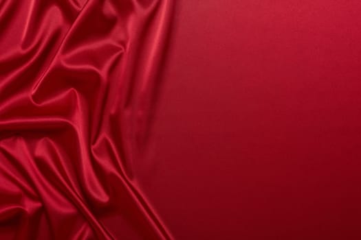 Abstract background from red silk or satin. Luxury fabric texture with draped. Top view with copy space. Element design. Valentine's day.