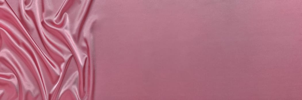 Abstract background from pink silk or satin. Luxury fabric texture with draped. Top view with copy space. Element design. Valentine's day.