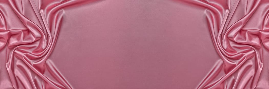 Abstract background from pink silk or satin. Luxury fabric texture with draped. Top view with copy space. Element design. Valentine's day.