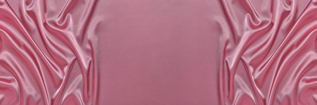Abstract background from pink silk or satin. Luxury fabric texture with draped. Top view with copy space. Element design. Valentine's day.