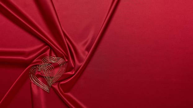 Abstract background from red silk (satin) and heart. Fabric texture with draped. Top view with copy space. Element design. Valentine's day. Wedding day. Greeting card