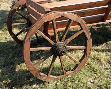 The antique wooden horse cart wheel.