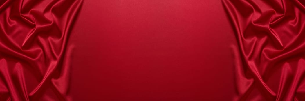 Abstract background from red silk or satin. Luxury fabric texture with draped. Top view with copy space. Element design. Valentine's day.