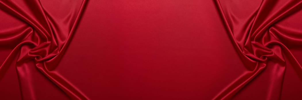 Abstract background from red silk or satin. Luxury fabric texture with draped. Top view with copy space. Element design. Valentine's day.