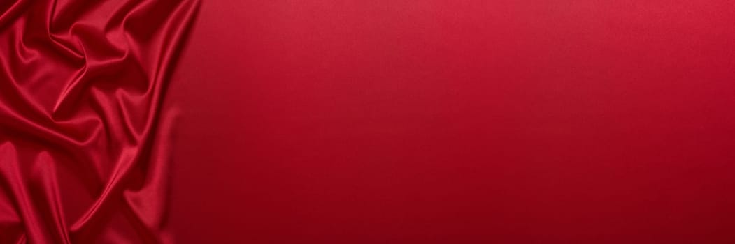 Abstract background from red silk or satin. Luxury fabric texture with draped. Top view with copy space. Element design. Valentine's day.