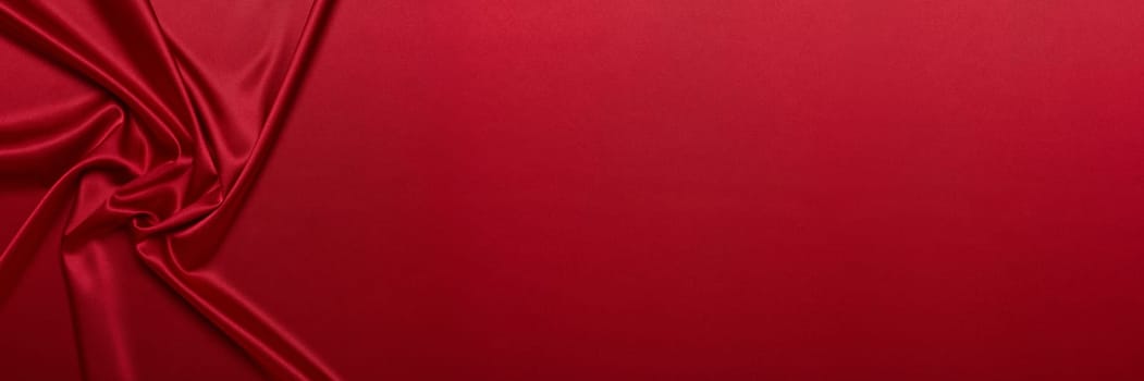 Abstract background from red silk or satin. Luxury fabric texture with draped. Top view with copy space. Element design. Valentine's day.