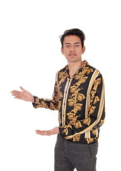 A tall young man standing in a gold colored shirt shoeing with his hands.isolated for white background.