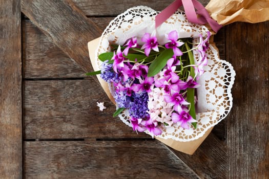Fresh orchids and hyacinths on a vintage wooden background