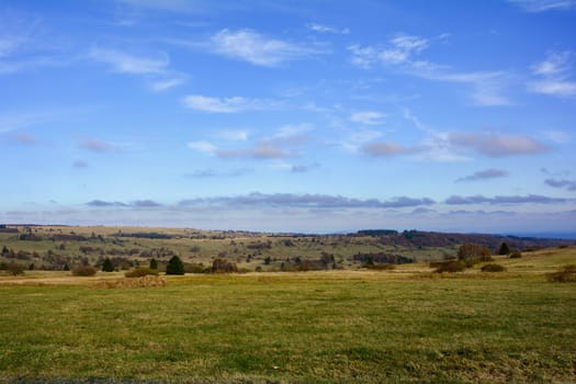 Landscape  with big meadow, trees and blue sky in the Rhön, Bavaria, Germany