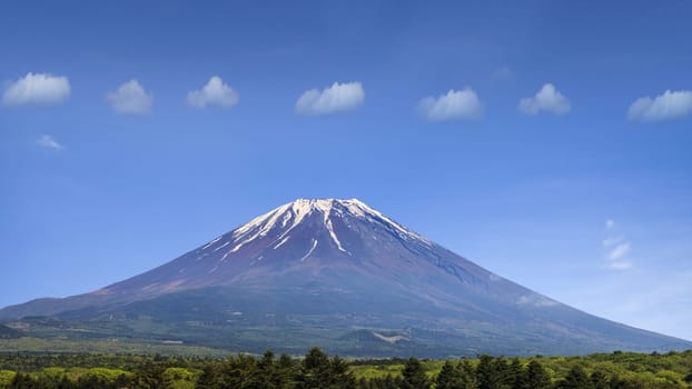 The nice mountain with align clouds with nice blue and green tree