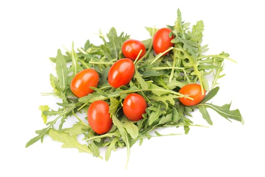 Salad with red cherry tomatoes and fresh arugula leaves isolated on a white background