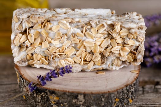 Handmade scrub soapHandmade scrub soap on a wooden stand with oatmeal for relaxation and water treatments