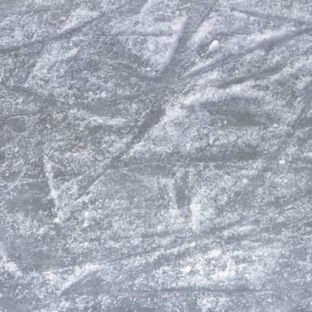 Ice surface. Close up of white ice surface with a traces left by the skates. Ideal for texture and backgrounds.