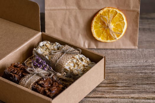 Handmade soap with natural fillers, in a gift cardboard box, next to an eco package, with jute decoration
