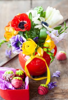 Bunch of colorful spring flowers in a little vase