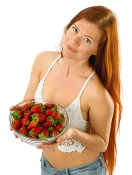Photo of a gorgeous young woman with long red hair holding a bowl of strawberries over white background.