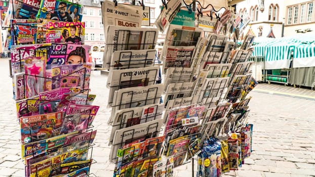 TRIER, GERMANY- SEPTEMBER 13 2019: German and international magazines and newspapers for sale at a german newsstand in TRIER, Germany.