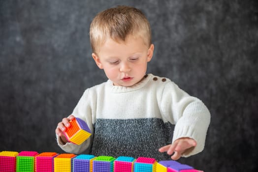 a two years old baby playing with cubes