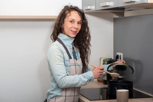 a young woman with long hair is in the kitchen