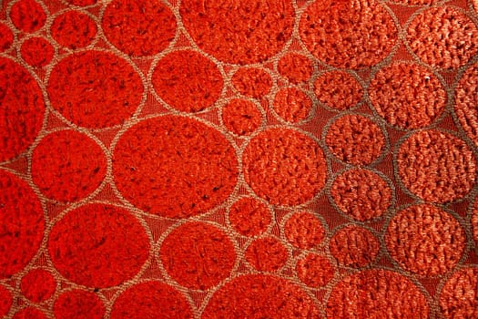 Red colored fabric with geometric design and woolly texture