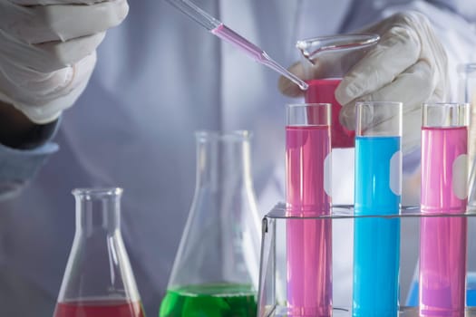 Researcher with glass laboratory chemical test tubes with liquid for analytical, medical, pharmaceutical and scientific research concept.