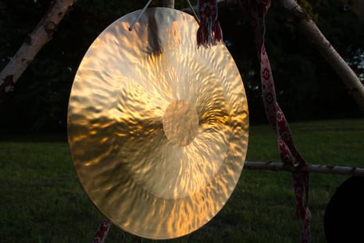gong in sunlights waiting for pagan rituals