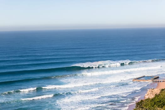 Wave swell crashing on coastline shoreline a birdseye air photo