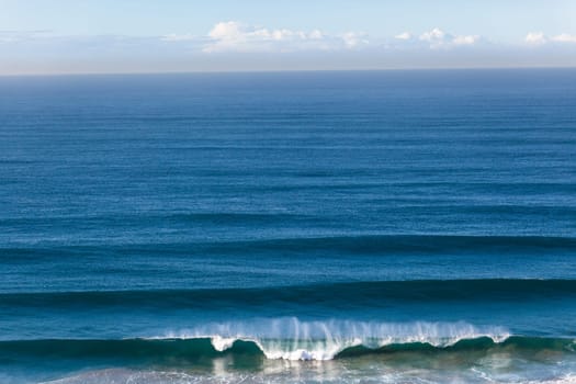 Wave swell crashing on coastline shoreline a birdseye air photo