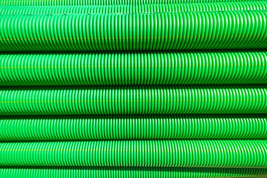 Plastic drainage pipes closeup green black abstract background detail