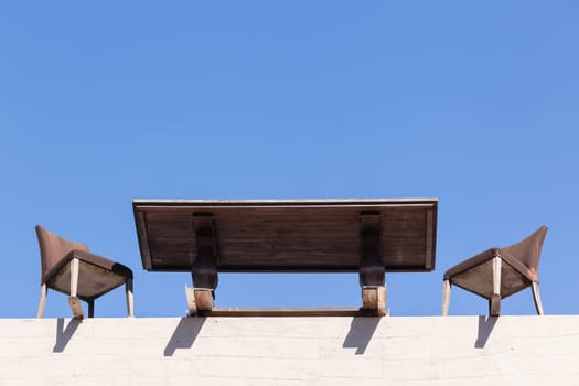 Chairs Table on edge of building outdoor in blue sky in abstract danger concept of trust integrity fraud .