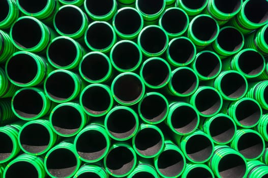 Plastic drainage pipes closeup green black abstract background detail