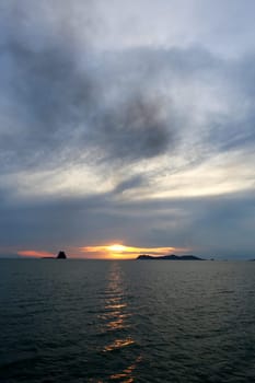 Sunset in the sea among the clouds