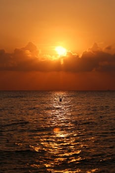 Sunset in the sea among the clouds