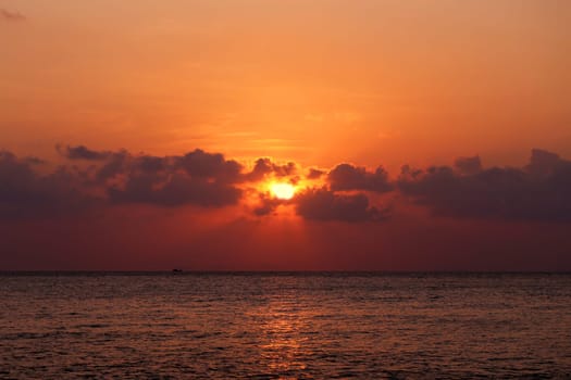 Sunset in the sea among the clouds