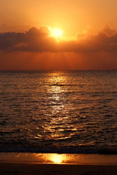 Sunset in the sea among the clouds