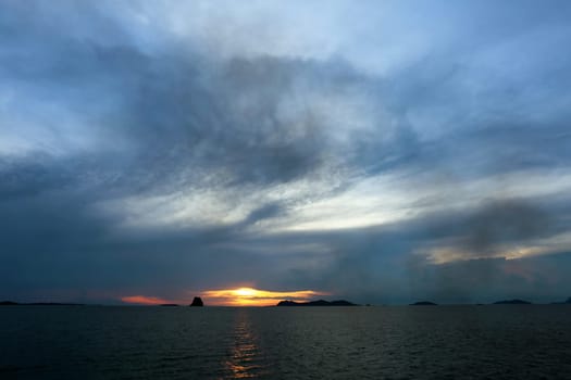 Sunset in the sea among the clouds