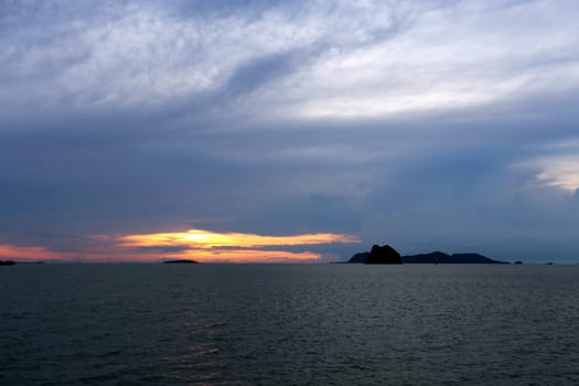 Sunset in the sea among the clouds