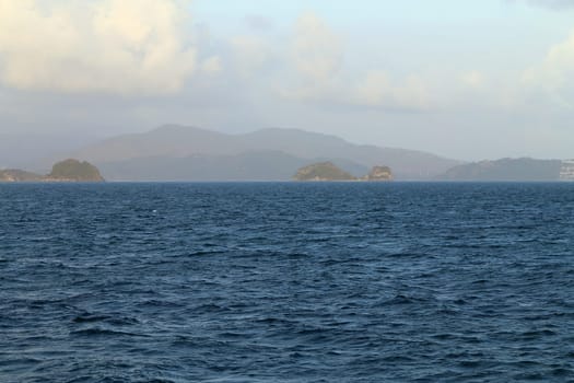 beautiful seascape with the island on the background of blue sky with