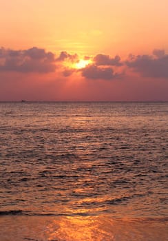 Sunset in the sea among the clouds