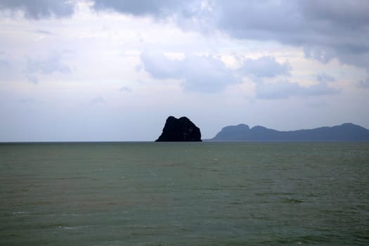beautiful seascape with the island on the background of blue sky with