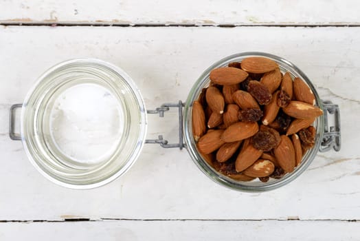 almonds with raisins dry in a glass jar