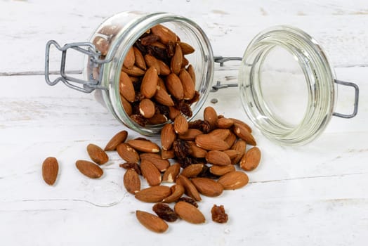 almonds with raisins dry in a glass jar